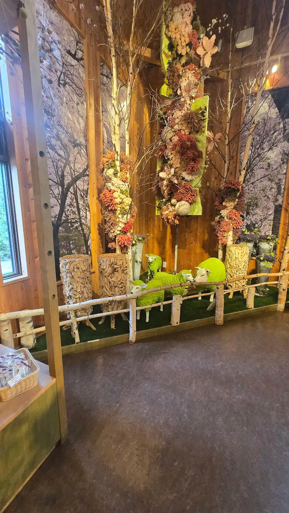 Indoor flower garden display with wooden bridge