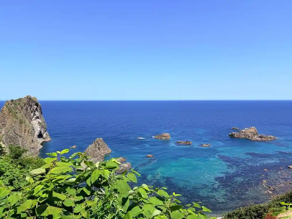 Rocky coastal cliffs with turquoise sea below